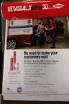 Picture of Able Auto Glass in Houston, TX  business card over a flyer of Dupont Xpress30 that 
    has a 30-minute Safe-Drive-Away-Time after the glass is set onto the body.