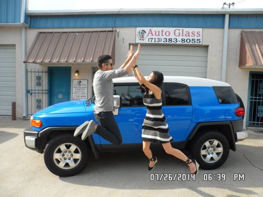 Photo of two of our clients jumping for joy at Able Auto Glass in Houston, TX